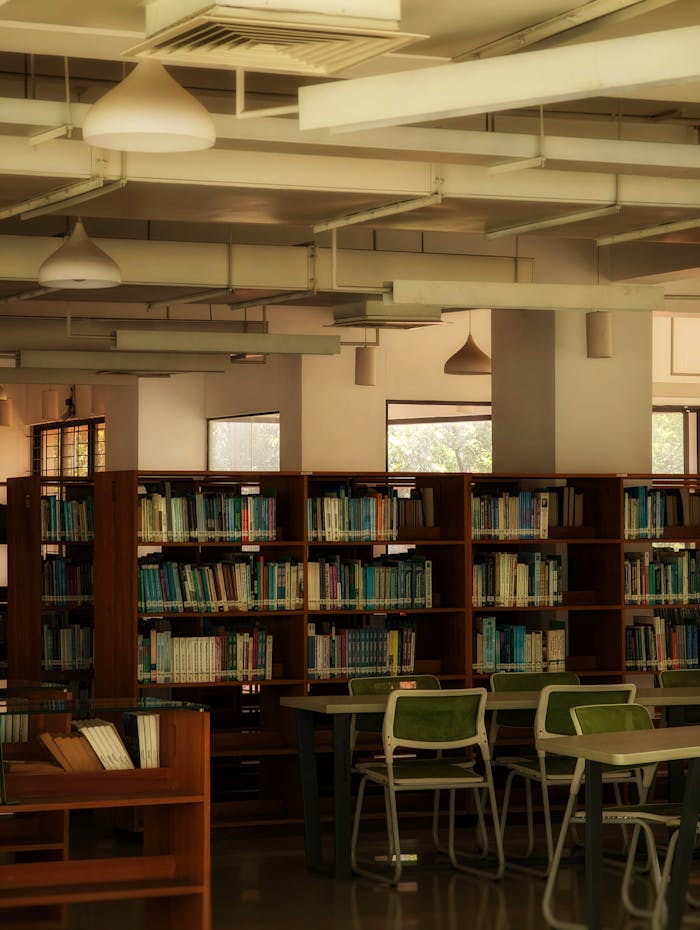 Cozy library setting in Savar, Bangladesh, featuring wooden bookshelves and reading tables.